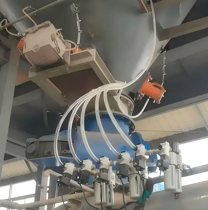 An industrial pneumatic vibrator system installed on a grey steel hopper to effectively resolve material blockages and bridging in a silo.