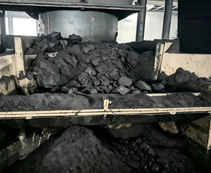 Severe material clogs and buildup at the discharge chute, forcing a production line shutdown.